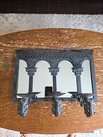 Front view of mirror with three candle holders