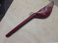 Full view of burgundy/tan fishing rod case exterior