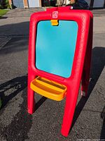 Front view showing teal side and yellow tray