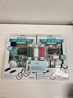 Front of two sealed earring making kits showing contents and branding