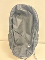 Front view of black Asics daypack showing overall design and side pockets
