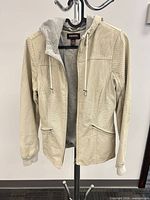 Full frontal view of jacket on hanger showing overall design and condition