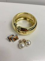 All items group shot showing bangle, pearl studs, square clip-ons