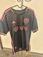 Front view showing crest, Adidas logo, sponsor and overall color scheme