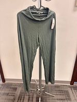 Front view of olive green wide-leg pants hanging