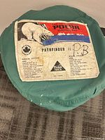Label on sleeping bag lid showing brand, model, specs