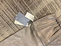 Waistband close-up with attached tags