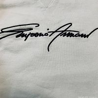 Close-up of embroidered Emporio Armani logo on chest