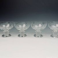 Front view of four crystal coupe glasses