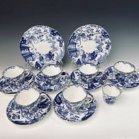 Full set laid out: cups, saucers, side plates