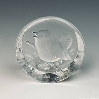 Front view of round crystal paperweight showing robin motif