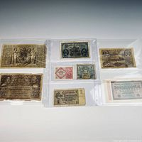 Six banknotes in sleeves, one side visible