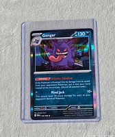 Front view of sleeved Gengar rainbow rare card shows artwork, HP130, ability Infinite Shadow, attack Mind Jack, holographic finish