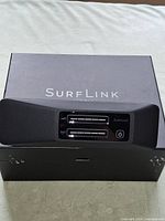 Front view of SurfLink 210 placed on original box
