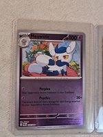 Pokémon TCG Meowstic Stage 1 card 034/088 in top loader showing holographic finish and surface condition