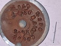 front view of disc showing stamped numbers and pin