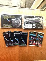 Group shot of shrink-wrapped postcard sets and six sealed card packs
