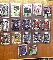 Front view of 15 of the sleeved Panini Absolute rookie cards displayed on a board