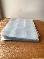 Stack of clear plastic 9-pocket pages viewed from side