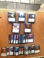 Front view of multiple stacks of Flesh and Blood cards on table