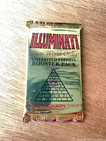 Front view of sealed booster pack showing title and pyramid design