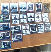 All 26 sleeved/top-loaded Draft Class rookie cards laid out