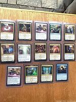 Fifteen of the sleeved/toploaded MTG rares displayed face-up on tabletop