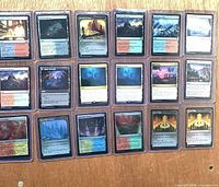 Front view of 18 of the sleeved land cards in rigid holders
