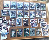 All 32 cards laid out in four rows on wooden surface