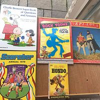 All four books and comics displayed together