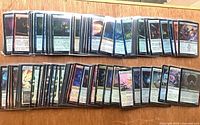 Two rows of sleeved foil MTG cards displayed face up