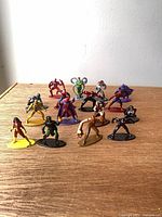 All 16 Marvel miniature figures on tabletop
