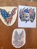 All three vinyl stickers laid out on wood surface