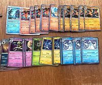 All 50 holographic Pokémon cards spread out on tabletop