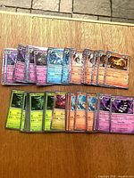 Full lot of roughly 50 rare holo/foil Pokémon cards laid out in two rows