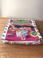 Front of opened display box showing Gruesome Greetings graphics and wear