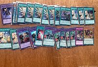 Top-down view of all 50 sleeved Yu-Gi-Oh! holographic cards laid out in rows