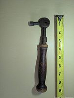 Full view of saw tooth setter beside measuring tape showing length