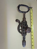 Full view of drill showing overall form and tape measure indicating length ~13 in.