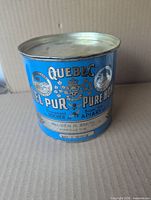 Front view of blue Quebec Pure Honey 4 lb tin