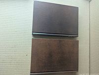 Two brown slipcased hardcovers top view