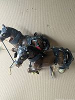 Two large Clydesdale horse figurines side view showing harness detail