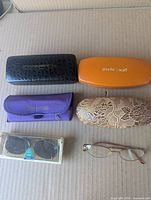 Six eyewear pairs with their respective cases displayed closed