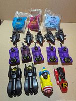 Array of loose and sealed Batman Happy Meal vehicles laid out in rows