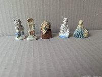 Front view of all five Wade nursery rhyme figurines lined up