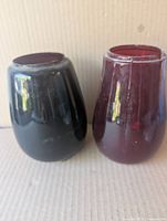 Two ruby red glass railroad lantern globes side by side