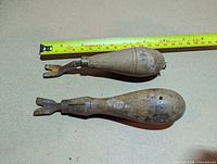 Two wood-handled leather edge creasers beside tape measure showing length