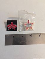Both CJOH No Stars lapel pins with ruler for scale