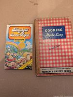 Front covers of the two cookbooks showing titles and designs