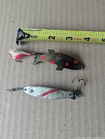 Both lures laid beside tape measure showing approximately 4 in. length